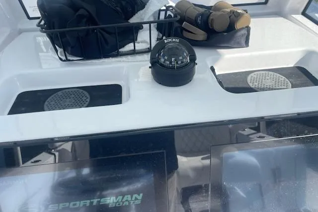 Slide: The Image of 2025 Sportsman Heritage 261 Center Console dashboard with compass and storage compartments. - 6