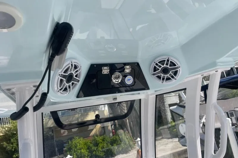Slide: The Image of 2025 Sportsman Heritage 261 Center Console boat dashboard with speakers and controls. - 7