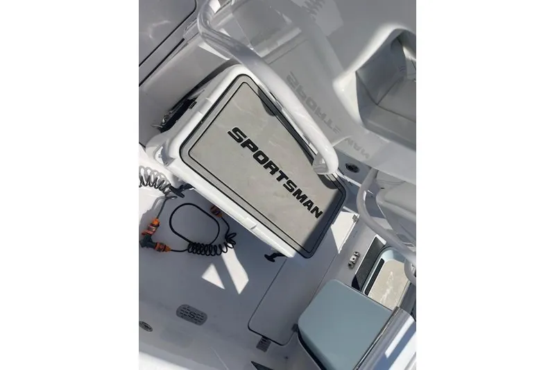 Slide: The Image of 2025 Sportsman Heritage 261 Center Console boat interior with branded storage compartment. - 9