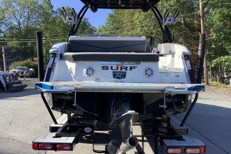 Slide: The Image of 2022 Cobalt R6 Surf boat rear view, parked outdoors, showcasing sleek design and features. - 3