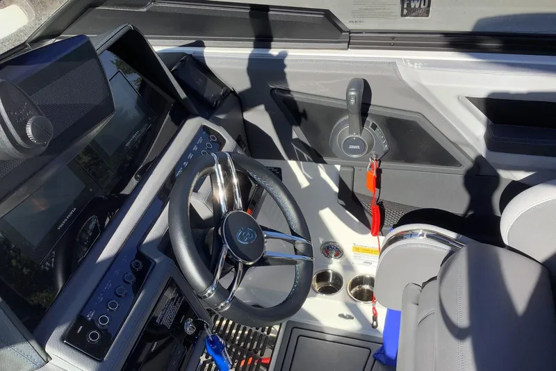 Slide: The Image of 2022 Cobalt R6 Surf boat cockpit with steering wheel and control panel. - 5