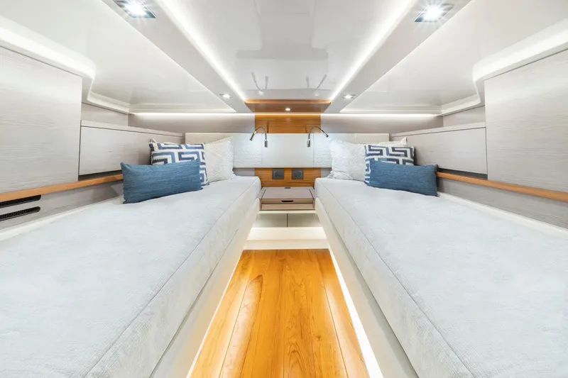 Slide: The Image of Manufacturer Provided Image: Luxurious interior of 2024 Tiara Yachts 48 LS with twin beds and modern lighting. - 15