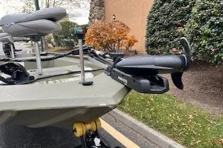 Slide: The Image of 2025 Tracker Grizzly 1754 AWL boat with mounted motor, parked outdoors. - 5