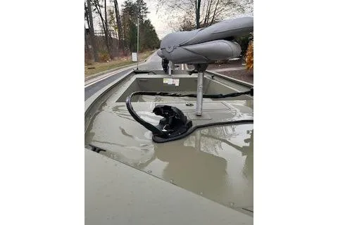 Slide: The Image of 2025 Tracker Grizzly 1754 AWL boat with seating, parked on a road. - 6