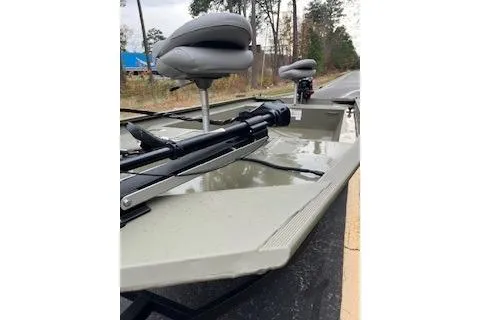 Slide: The Image of 2025 Tracker Grizzly 1754 AWL boat with seating and motor on a road. - 8