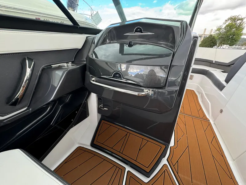 Slide: The Image of 2022 Monterey 258 Super Sport boat interior with sleek dashboard and stylish flooring. - 18