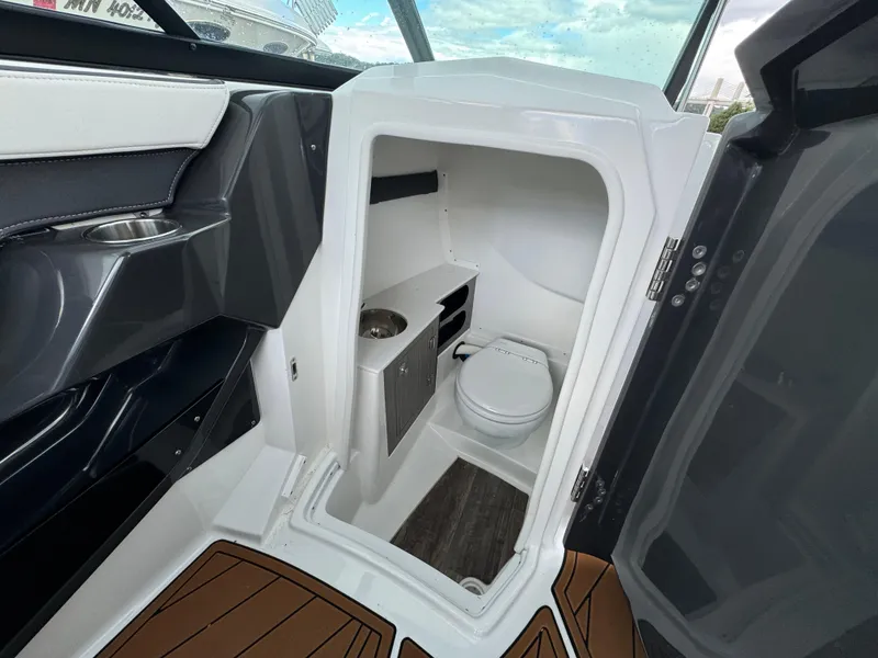Slide: The Image of 2022 Monterey 258 Super Sport boat interior with compact bathroom and toilet. - 19