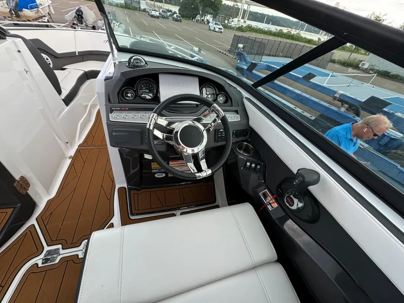 Slide: The Image of 2022 Monterey 258 Super Sport boat interior with steering wheel and dashboard controls. - 24