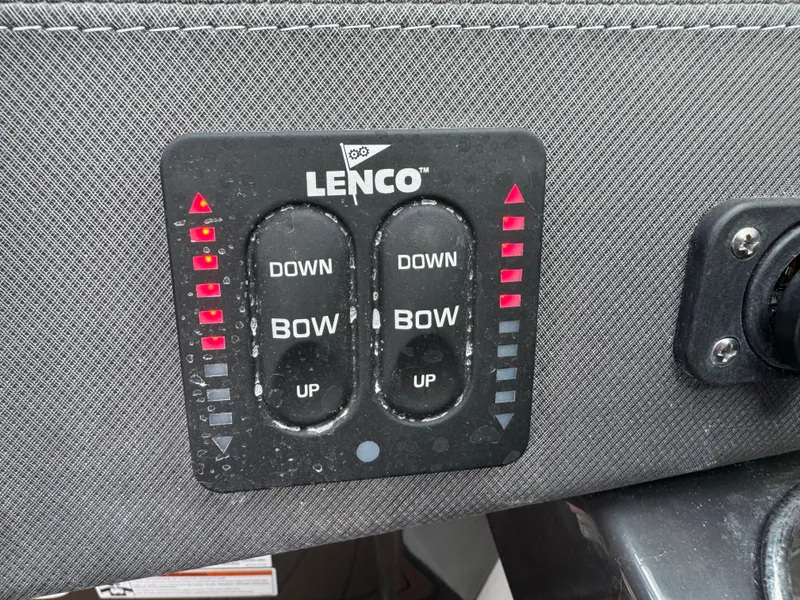 Slide: The Image of Lenco trim tab control panel on 2022 Monterey 258 Super Sport boat dashboard. - 28