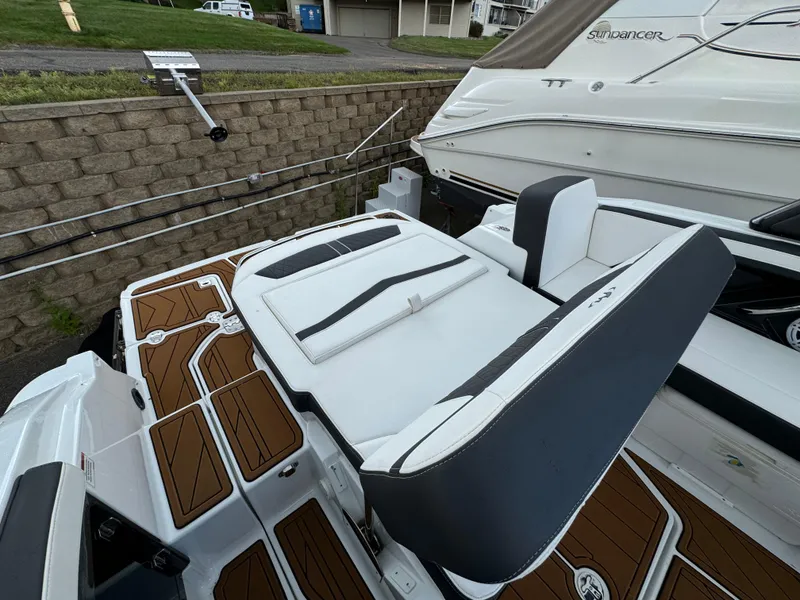 Slide: The Image of 2022 Monterey 258 Super Sport boat with sleek seating and wood-patterned deck. - 38