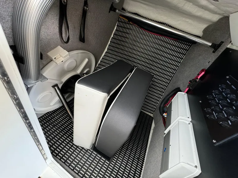 Slide: The Image of Interior of a 2022 Monterey 258 Super Sport boat, featuring storage and seating area. - 40