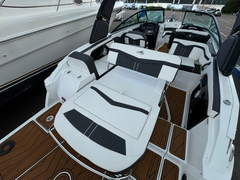 Slide: The Image of 2022 Monterey 258 Super Sport boat with sleek white and black seating, docked at marina. - 6