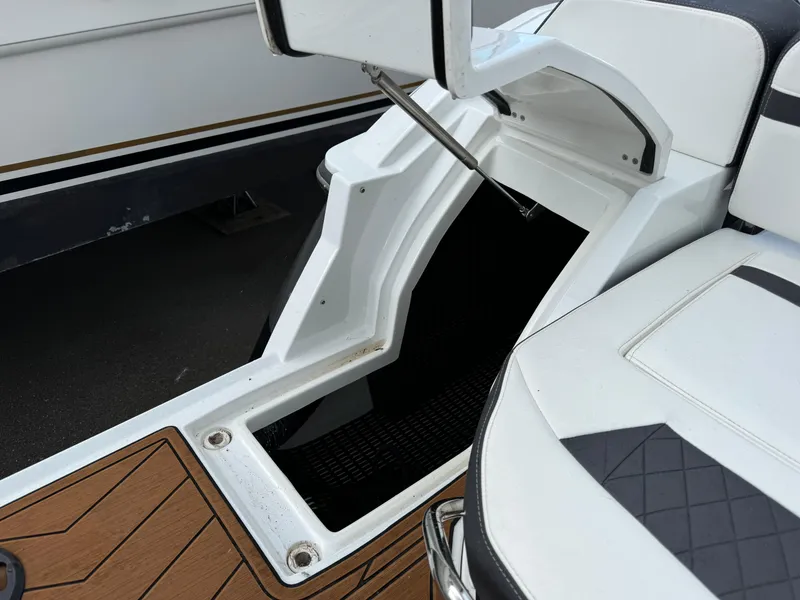 Slide: The Image of 2022 Monterey 258 Super Sport boat interior with white seating and wood accents. - 7