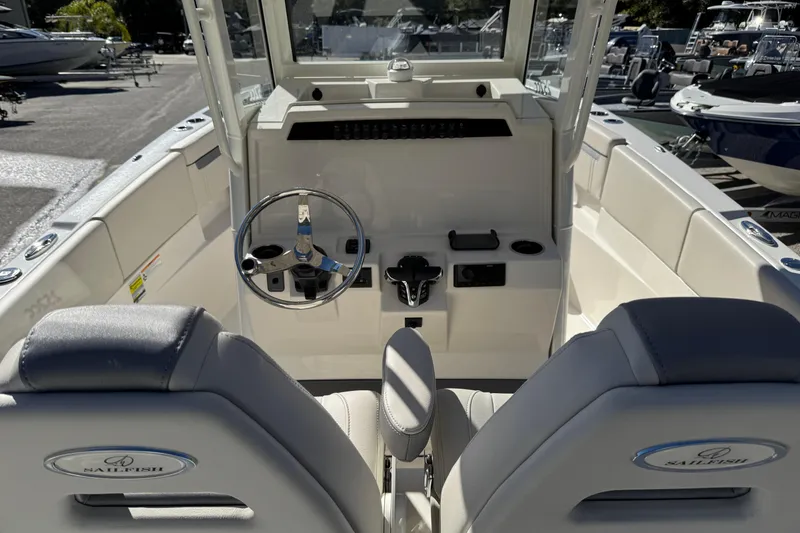 Slide: The Image of 2026 Sailfish 252 CC boat cockpit with Garmin navigation system and steering wheel. - 17
