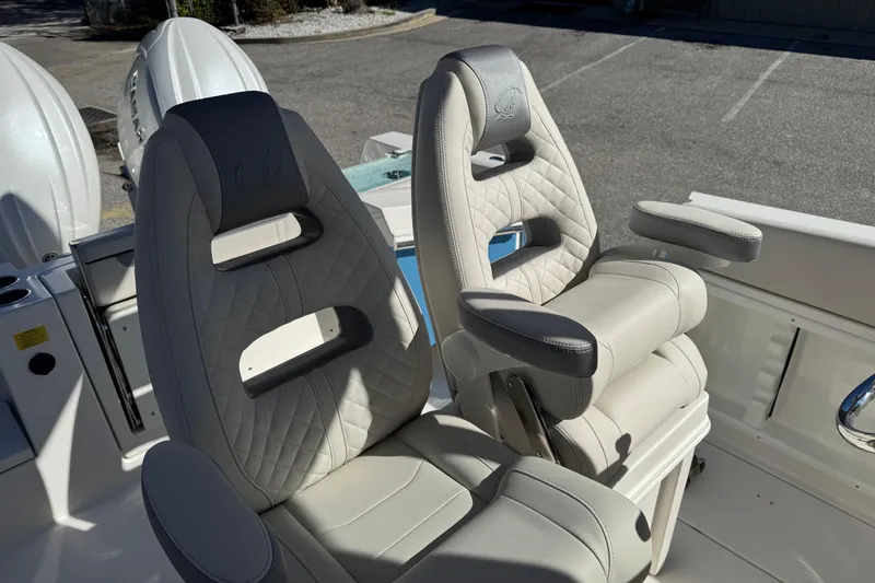 Slide: The Image of 2026 Sailfish 252 CC boat storage compartments with open doors. - 19