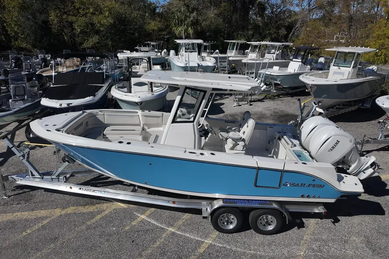 Slide: The Image of 2026 Sailfish 252 CC boat on trailer, surrounded by other boats in a lot. - 2