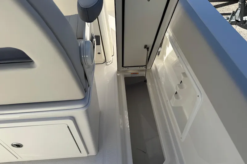 Slide: The Image of Bow anchor compartment of 2026 Sailfish 252 CC boat, featuring chain and winch. - 21