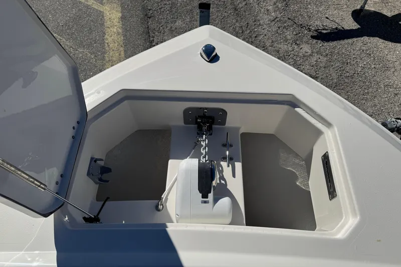 Slide: The Image of 2026 Sailfish 252 CC boat interior with open storage compartments and seating area. - 22