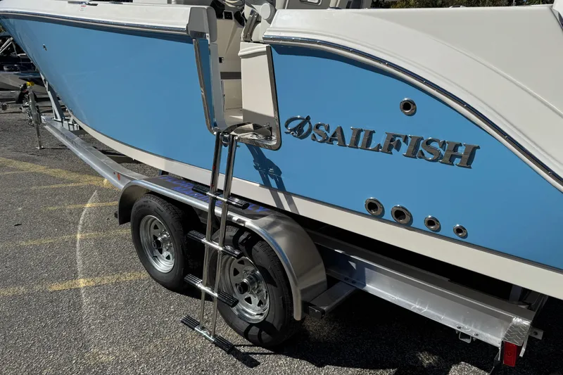 Slide: The Image of 2026 Sailfish 252 CC boat on trailer, featuring blue and white design. - 3