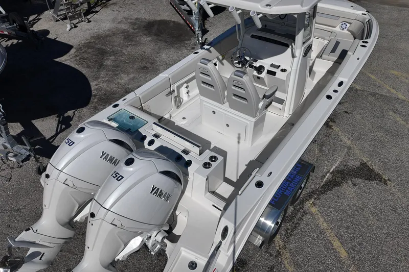 Slide: The Image of 2026 Sailfish 252 CC boat with dual Yamaha engines, spacious deck, and modern helm. - 7