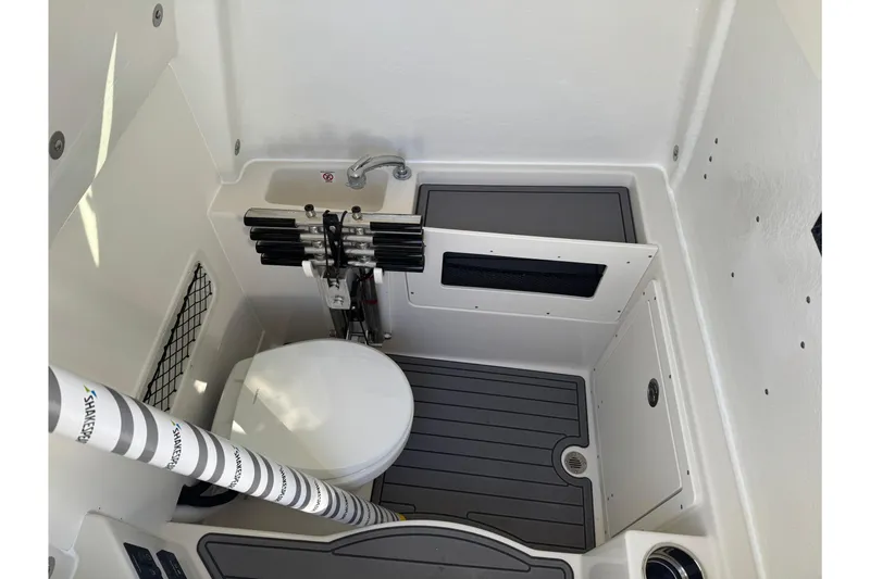 Slide: The Image of 2026 Sailfish 272 SE CC boat interior with cushioned seating and sleek design. - 12