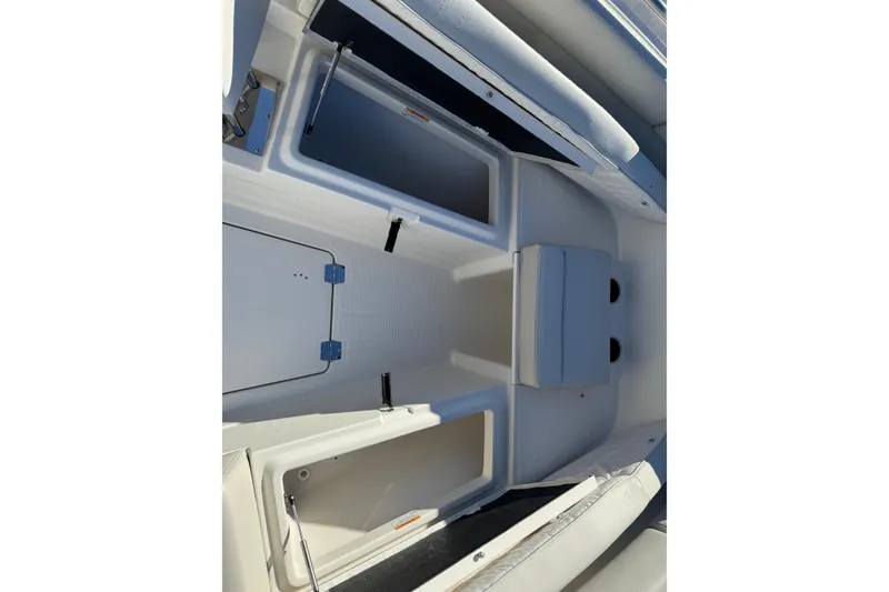 Slide: The Image of 2026 Sailfish 272 SE CC boat anchor compartment, open lid, showing anchor and chain. - 20