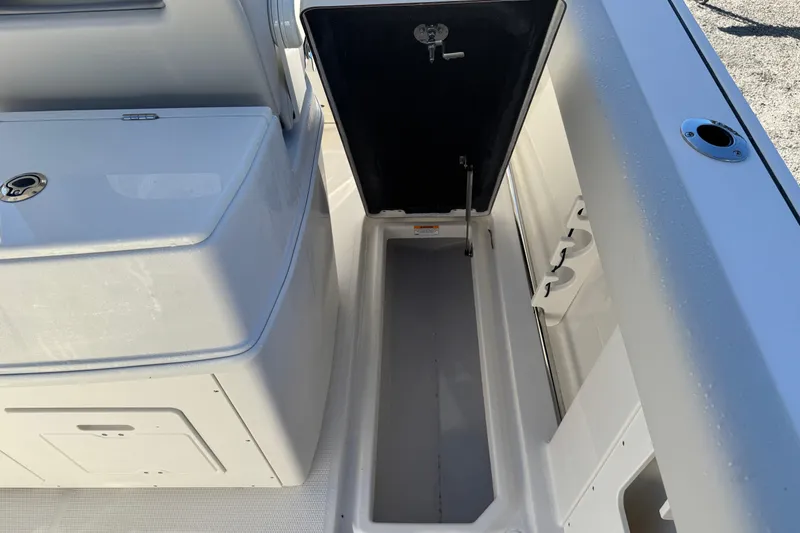 Slide: The Image of 2026 Sailfish 272 SE CC boat console with open glass compartment and Mercury engine. - 24