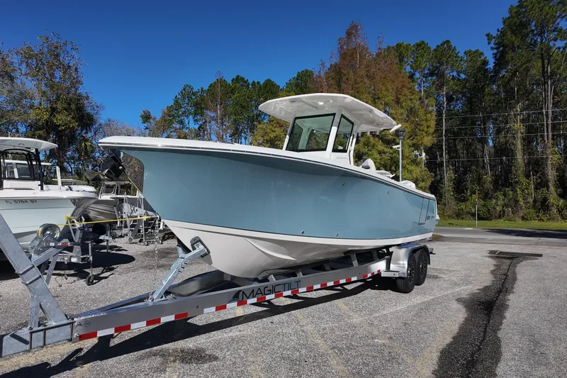Slide: The Image of 2026 Sailfish 272 SE CC boat on trailer, side view, clear blue sky background. - 3