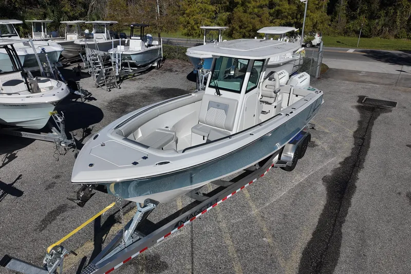 Slide: The Image of 2026 Sailfish 272 SE CC boat on trailer, surrounded by other boats in a lot. - 4
