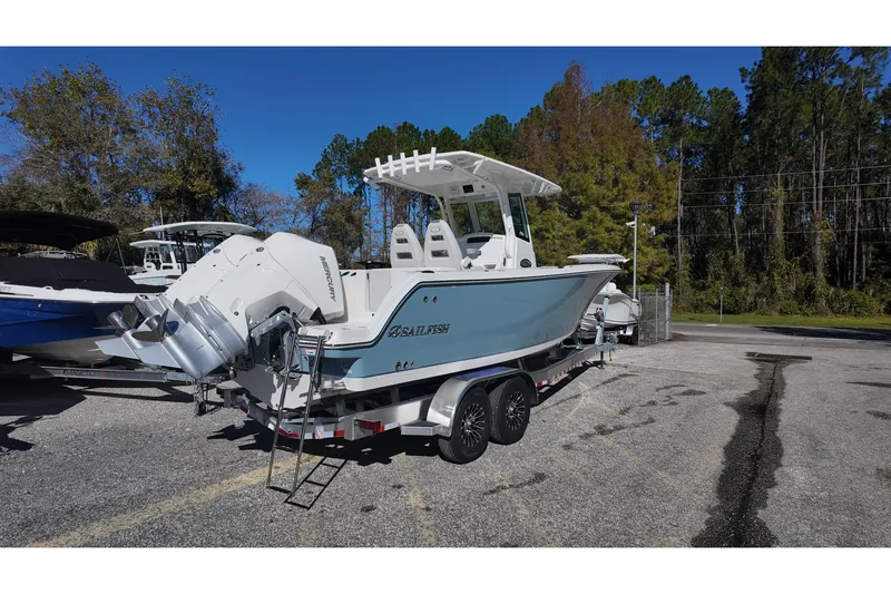 Slide: The Image of 2026 Sailfish 272 SE CC boat on trailer, parked outdoors under clear blue sky. - 5