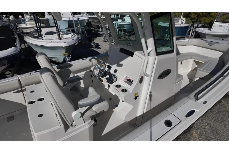 Slide: The Image of 2026 Sailfish 272 SE CC boat on trailer, parked outdoors. - 7