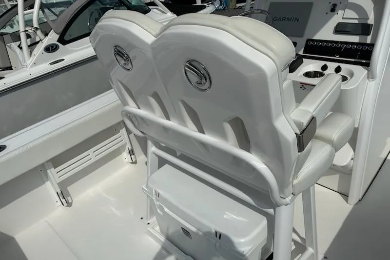 Slide: The Image of 2022 Edgewater 230CC boat interior with dual seats and Garmin navigation system. - 11