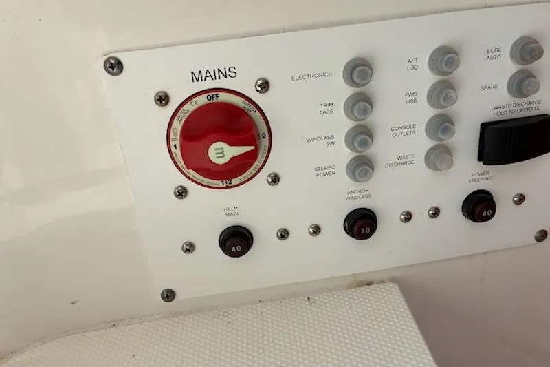 Slide: The Image of Control panel of 2022 Edgewater 230CC boat with switches and main power dial. - 15