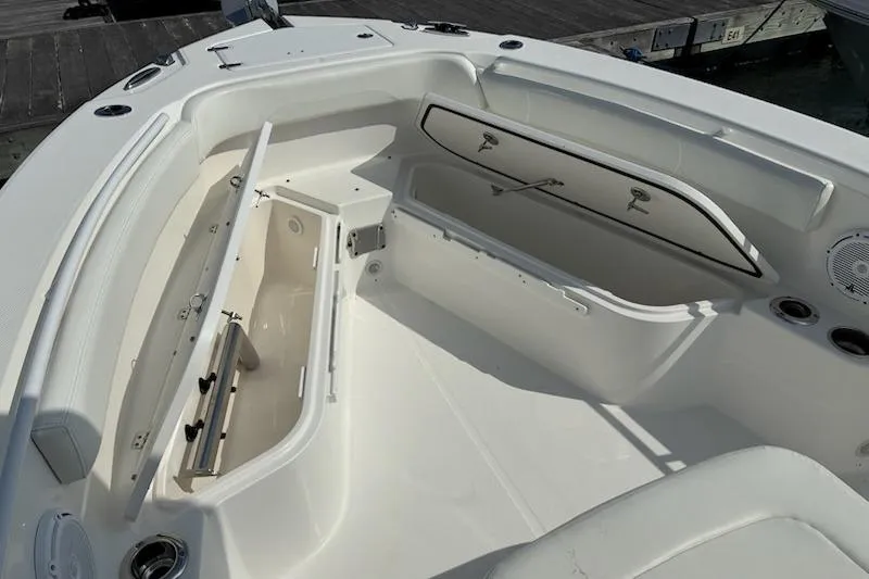 Slide: The Image of 2022 Edgewater 230CC boat interior with open storage compartments and seating. - 17