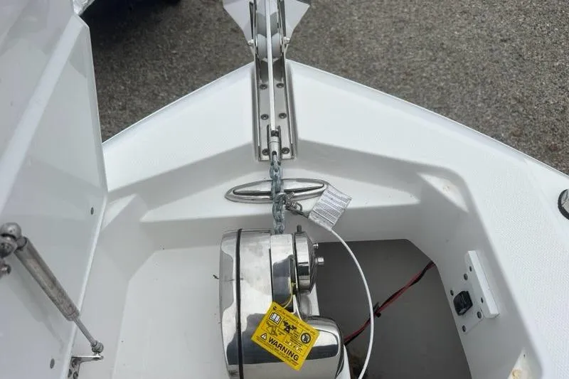 Slide: The Image of 2022 Edgewater 230CC boat anchor system with chain and warning label. - 19