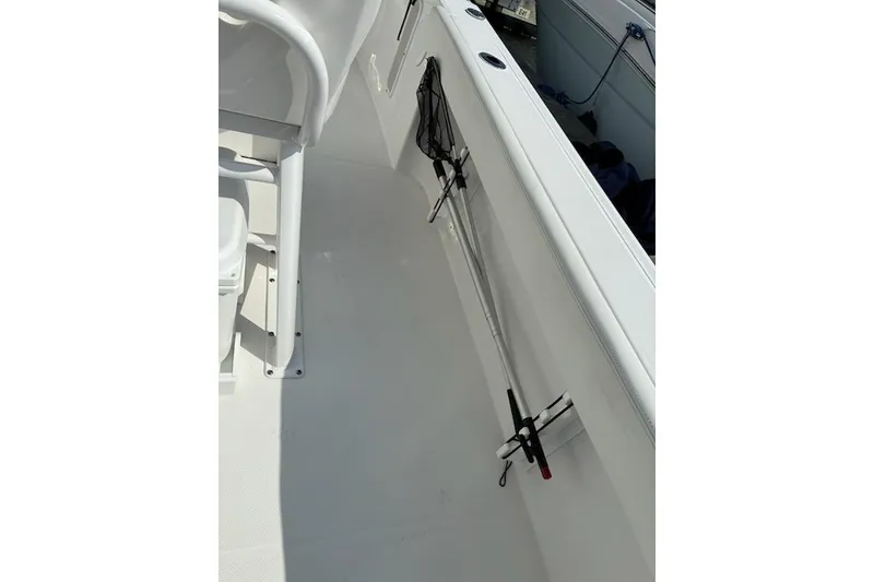 Slide: The Image of 2022 Edgewater 230CC boat interior with fishing rod holder and seating. - 22