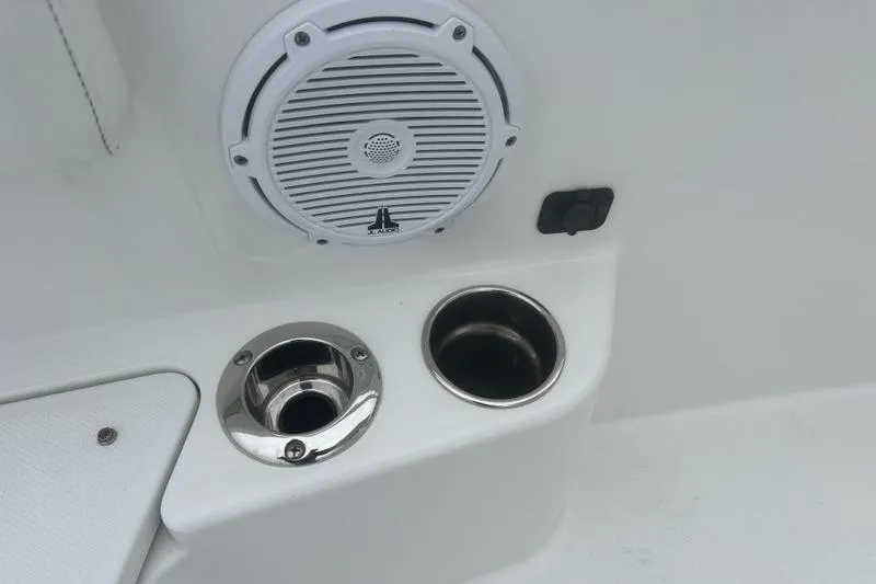Slide: The Image of 2022 Edgewater 230CC boat speaker and cup holders on white interior. - 26