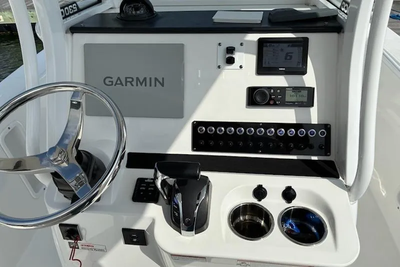 Slide: The Image of Edgewater 230CC 2022 boat dashboard with Garmin navigation system and control panel. - 3