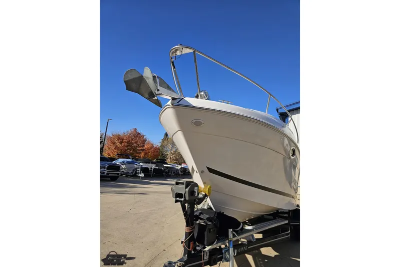Slide: The Image of 2008 Four Winns V258 boat on trailer under clear blue sky. - 11