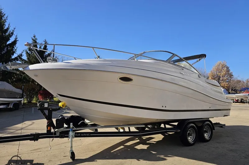 Slide: The Image of 2008 Four Winns V258 boat on trailer under clear blue sky. - 12