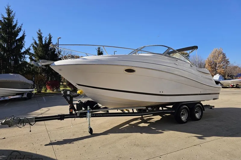 Slide: The Image of 2008 Four Winns V258 boat on trailer, parked outdoors on a sunny day. - 13