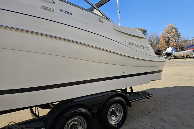 Slide: The Image of 2008 Four Winns V258 boat on trailer, side view, outdoors. - 16