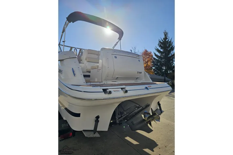 Slide: The Image of 2008 Four Winns V258 boat with dual propellers, docked under clear blue sky. - 20