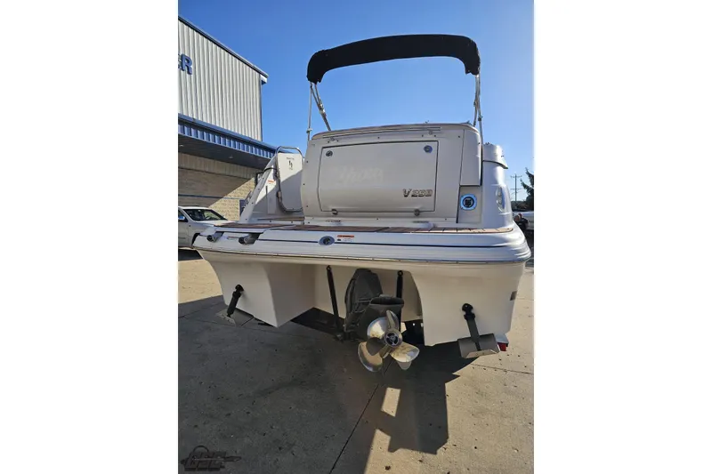 Slide: The Image of 2008 Four Winns V258 boat rear view with propeller and canopy. - 21