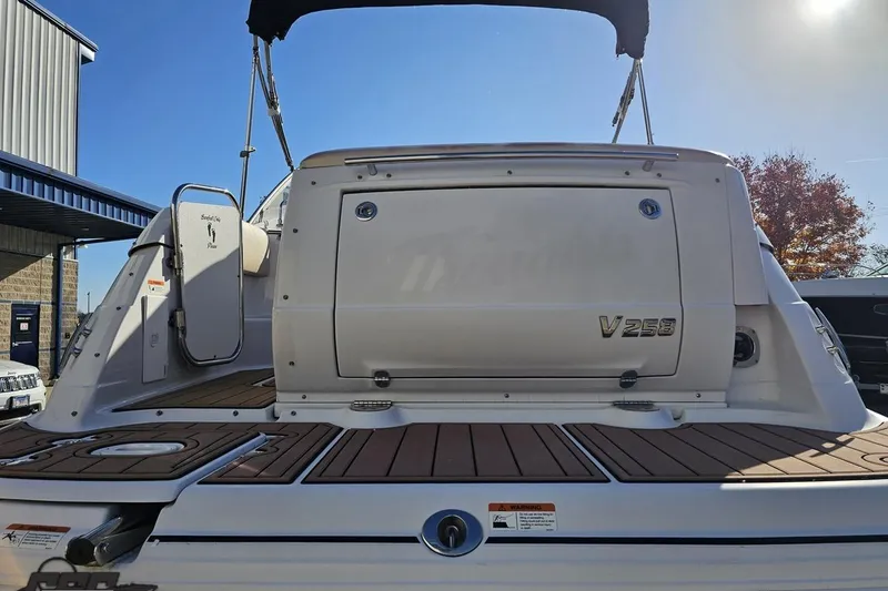 Slide: The Image of 2008 Four Winns V258 boat rear view with open deck and sunny sky. - 22