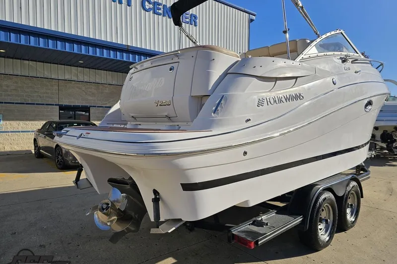 Slide: The Image of 2008 Four Winns V258 boat on trailer outside a marine center. - 23