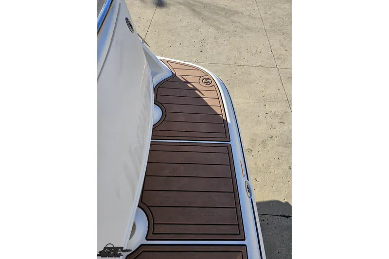 Slide: The Image of 2008 Four Winns V258 boat deck with wood finish, docked on concrete surface. - 24