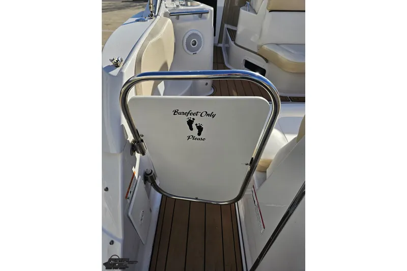 Slide: The Image of 2008 Four Winns V258 boat interior with "Barefoot Only" sign on gate. - 27