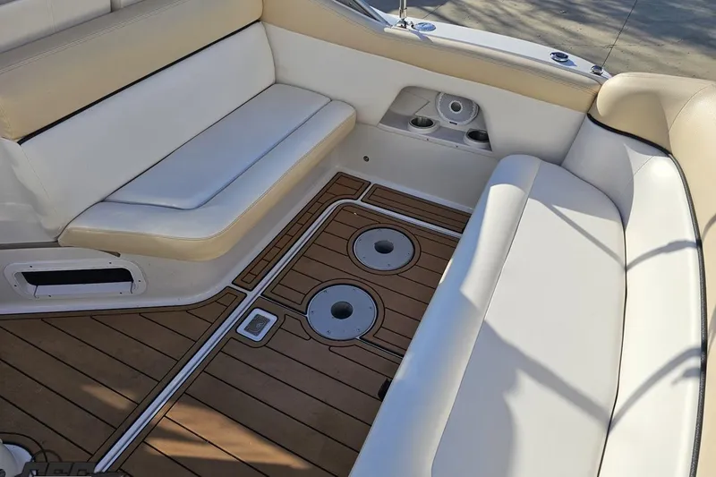 Slide: The Image of 2008 Four Winns V258 boat interior with white seating and wood-patterned flooring. - 31