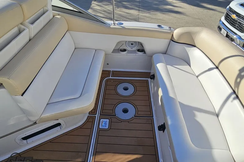 Slide: The Image of 2008 Four Winns V258 boat interior with beige seating and wood-patterned flooring. - 32